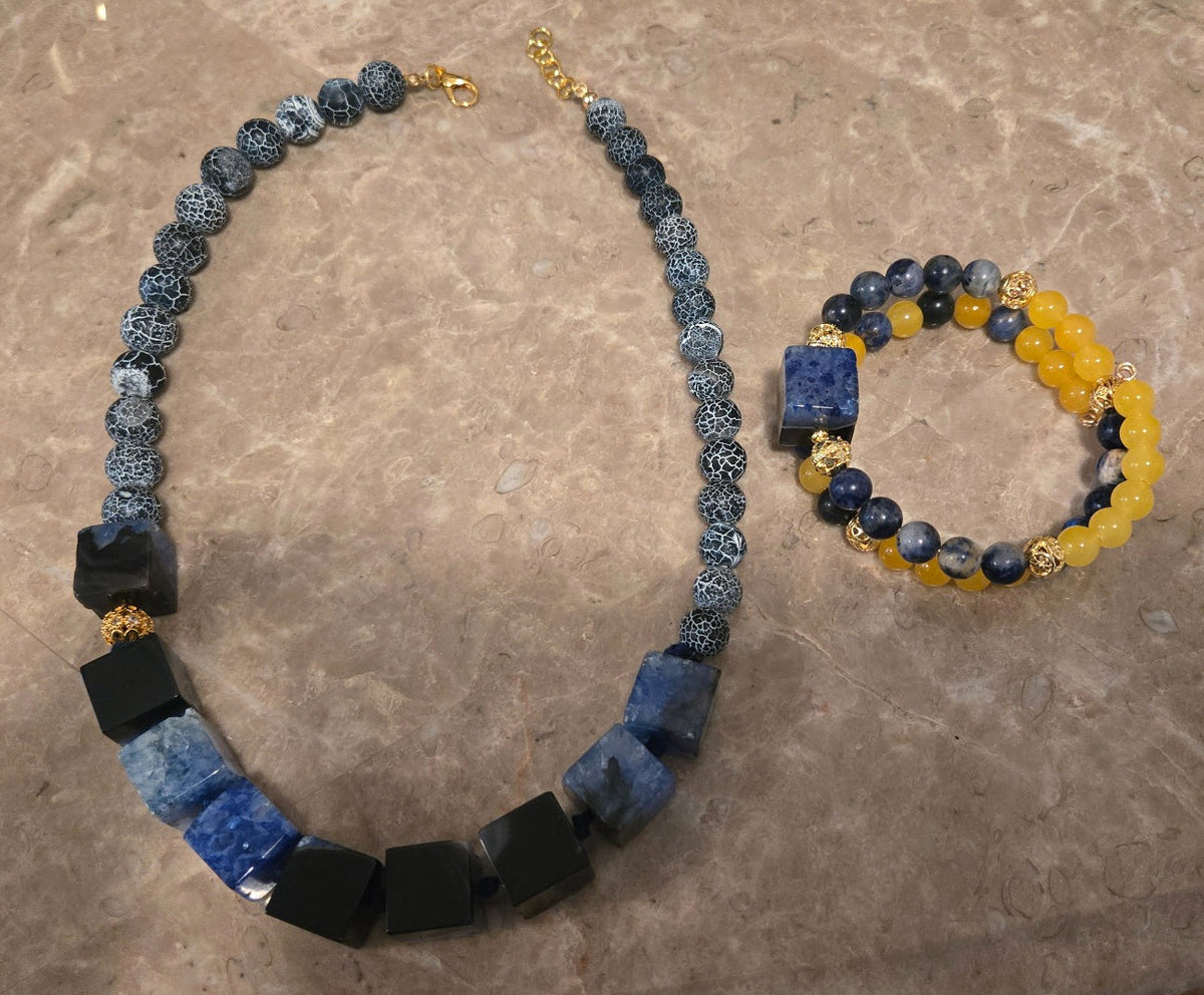 Blue and yellow Midnight & Marigold jewelry collection by ZoharasVogue with geometric cube necklace and beaded bracelet.