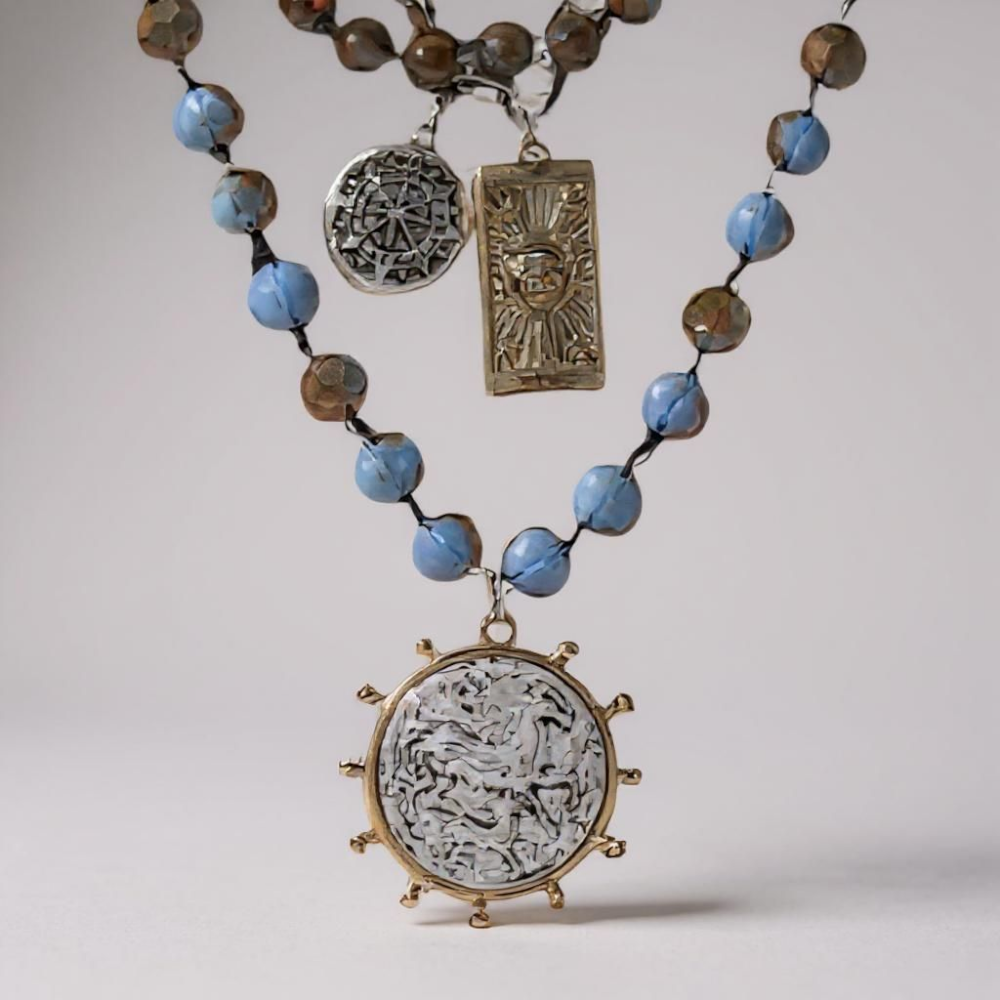 Suggestion


Necklace with blue beads and decorative pendants on a light background_ZoharasVogue