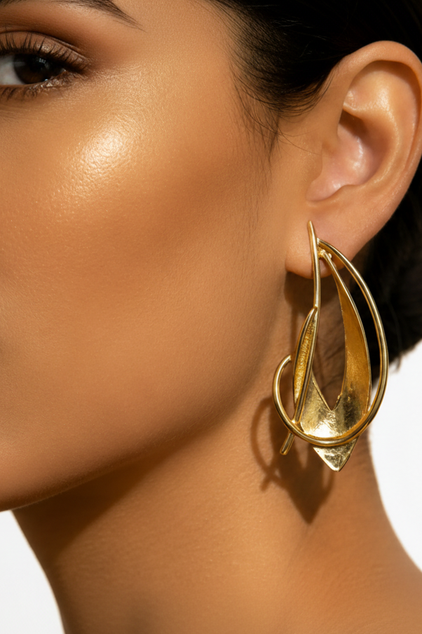 Close-up of a model wearing a gold earring with a neutral background_Zoharas Vogue