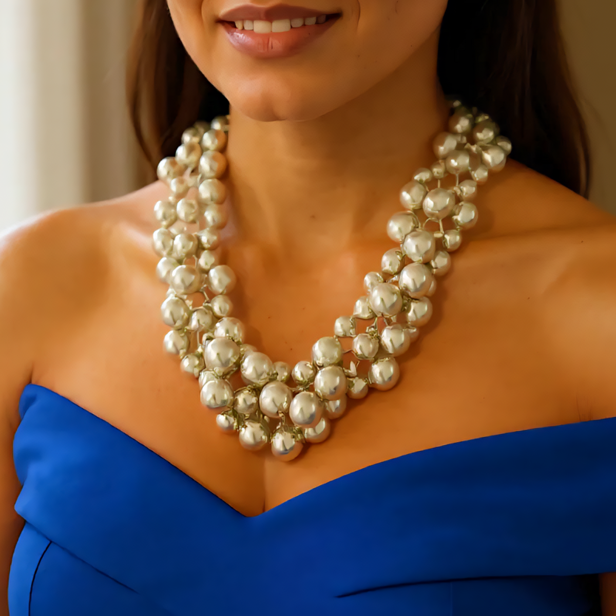 Polished plated beaded statement necklace with layered design, bold and modern jewelry.