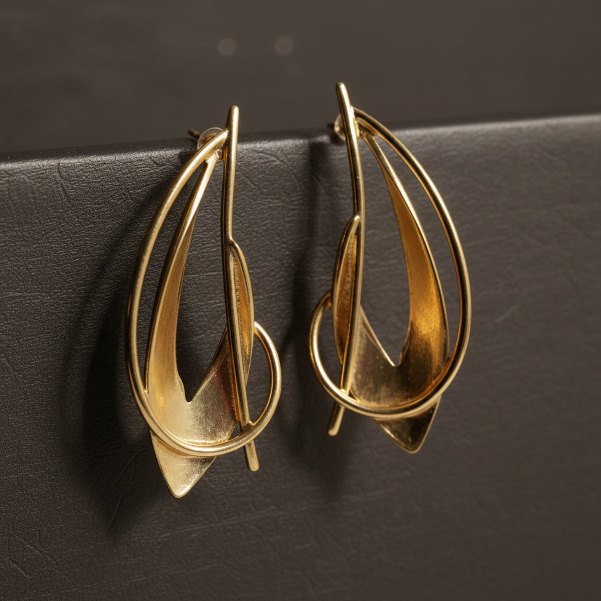Gold earrings on a white background_ZoharasVogue