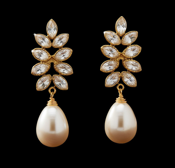 Gold earrings with floral designs and pearl drops on a white background. ZoharasVogue 