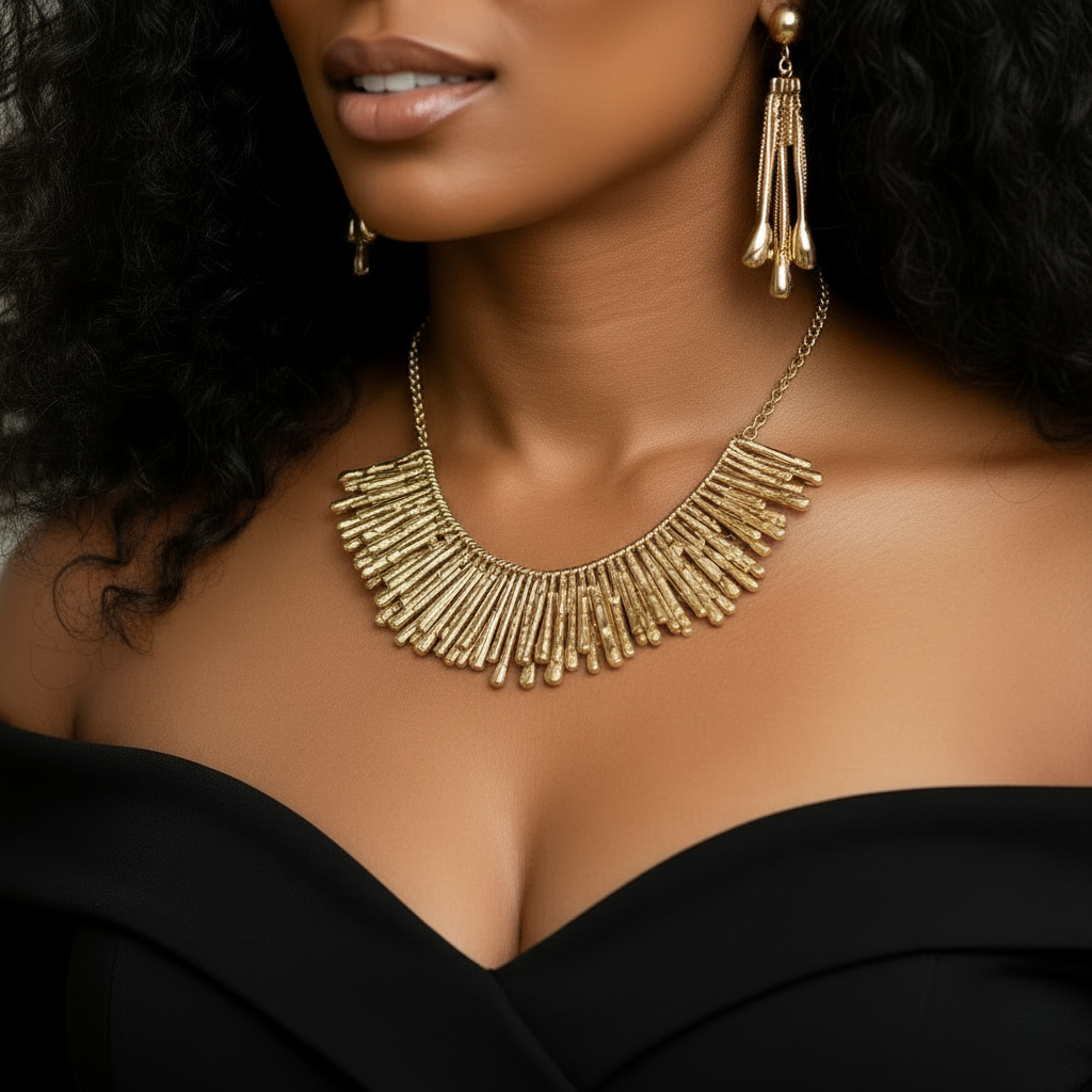 Close-up of hammered 18K gold-plated brass statement earrings with tapered fringe design, photographed on a model. ZoharasVogue