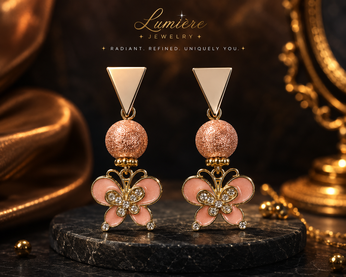Blush Butterfly statement earrings with pink enamel butterflies, sparkling crystal accents, textured rose-gold-tone beads and geometric tops. ZoharasVogue 