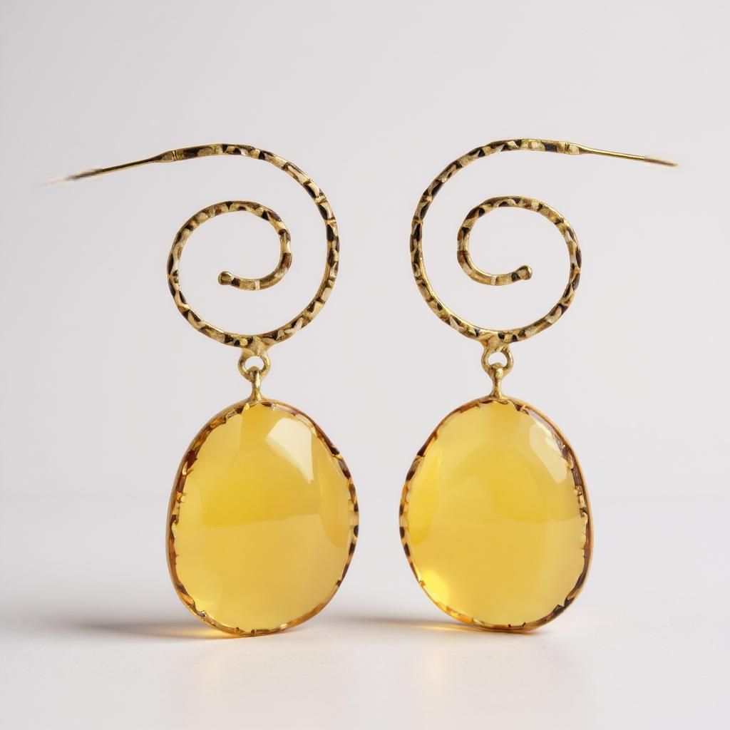 Gold earrings with yellow oval stones on a white background. ZoharasVogue