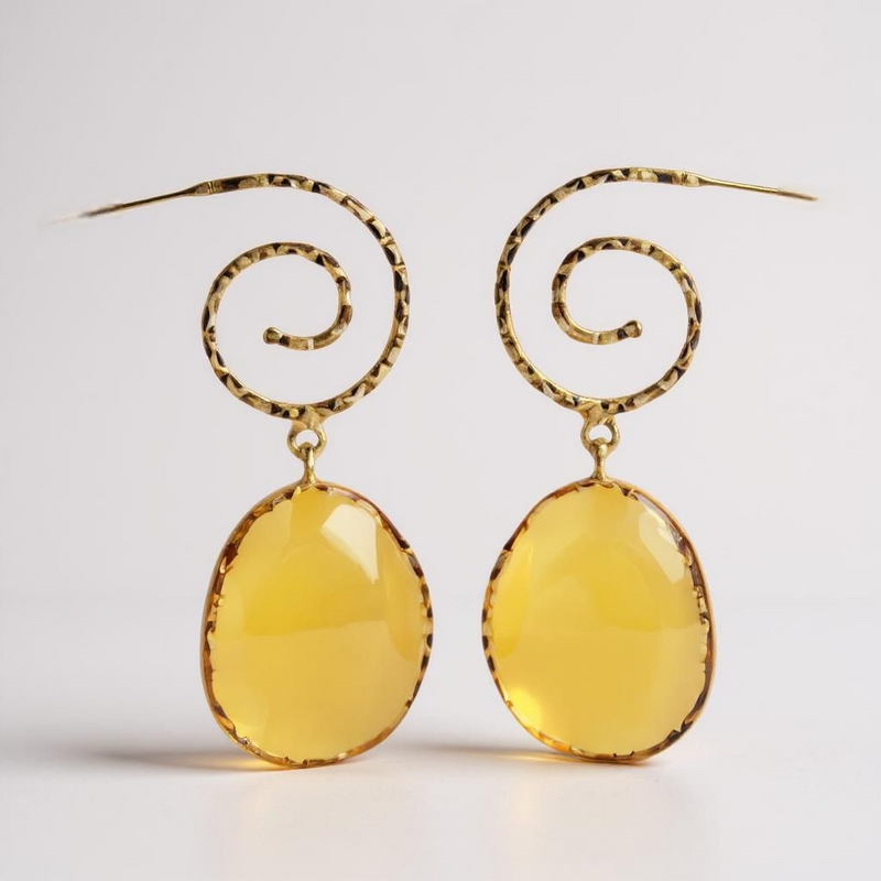 Gold earrings with yellow oval stones on a white background. ZoharasVogue