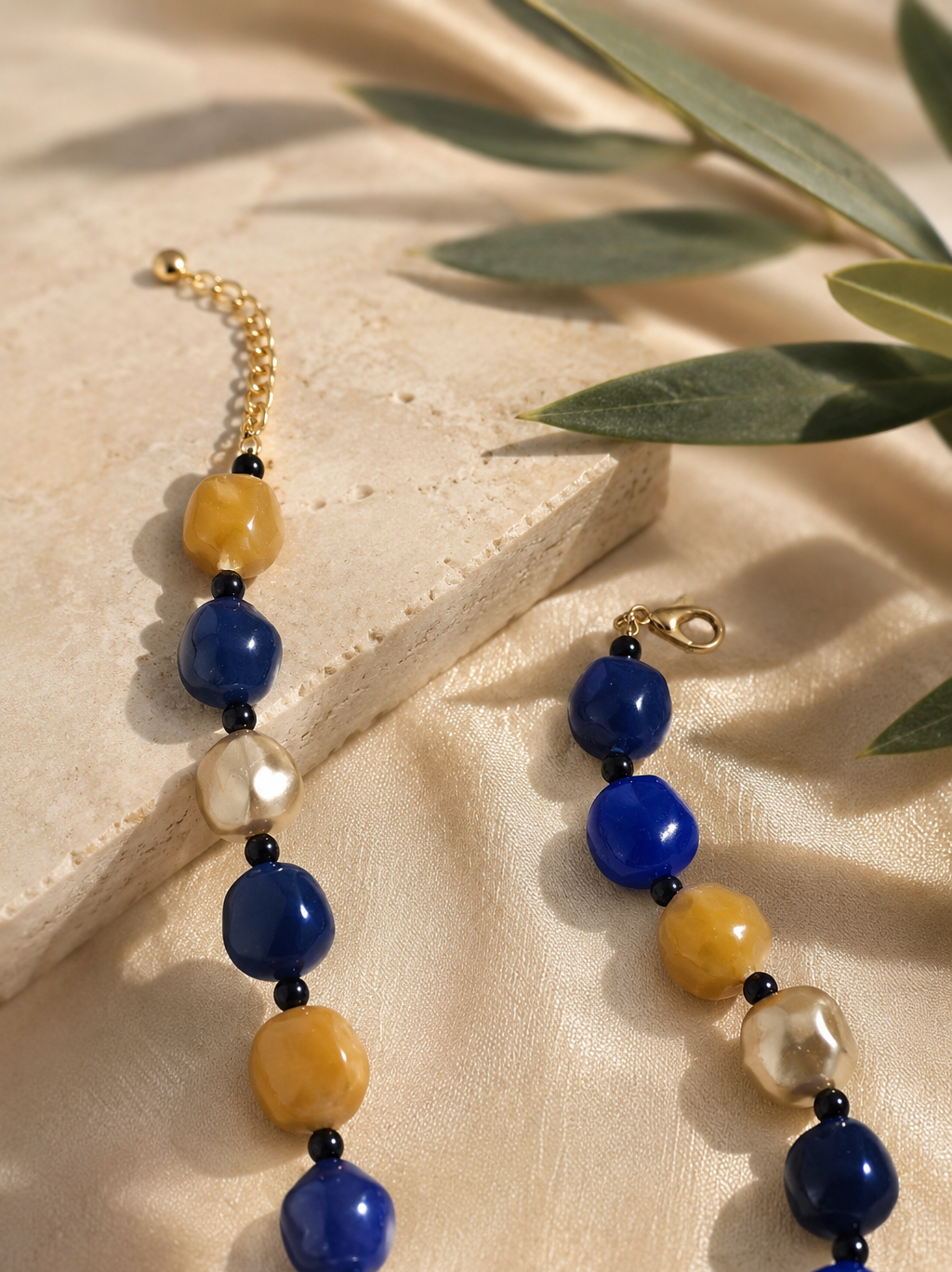Cobalt Mosaic Statement Necklace, cobalt blue, mustard yellow, turquoise and pearl-tone beaded statement necklace with black spacers, striped accent bead and silver-tone adjustable clasp. ZoharasVogue 
