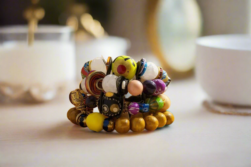 A vibrant 4-piece multicolor beaded bracelet stack with wire accents, styled for boho-chic fashion.