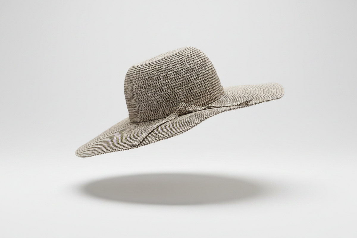 A studio display of the ZoharasVogue Ebony Straw Beach Hat, showcasing its solid black raffia weave, structured jazz crown, and dramatic 13cm wide brim.