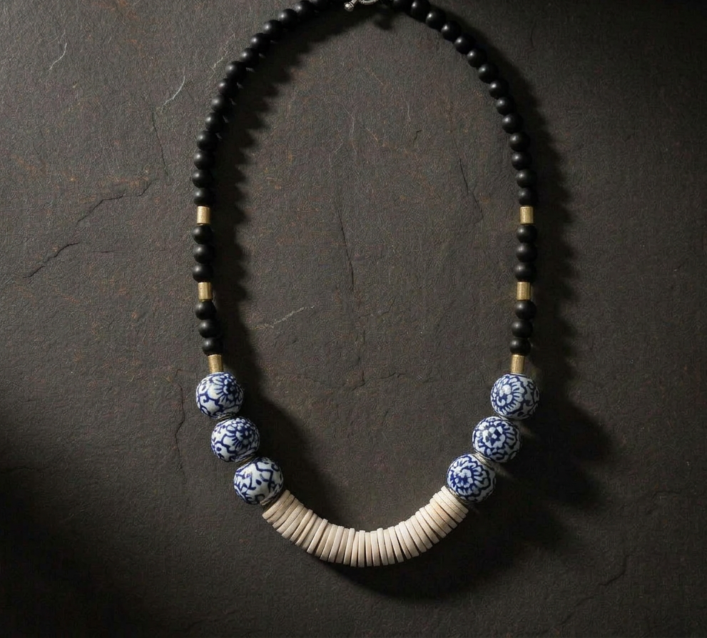 Indigo Haven Necklace, black and blue patterned beads with ivory disc centerpiece 