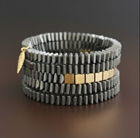 Eclat_Gold_Bracelet a handcrafted 5-strand hematite and brass bracelet made to order in New Jersey. Each piece is unique, reflecting modern elegance and artisan craftsmanship.ZoharasVogue