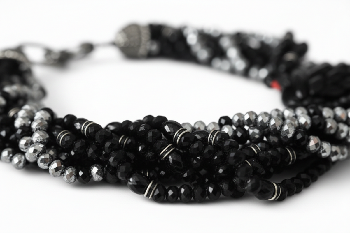 Elara Midnight Swan Necklace featuring layered faceted black and silver glass beads with rhinestone details and oversized pavé clasp.