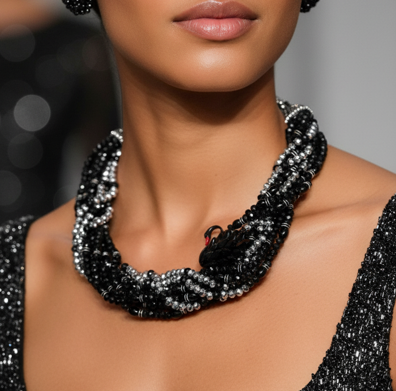 Elara Midnight Swan Necklace featuring layered faceted black and silver glass beads with rhinestone details and oversized pavé clasp.