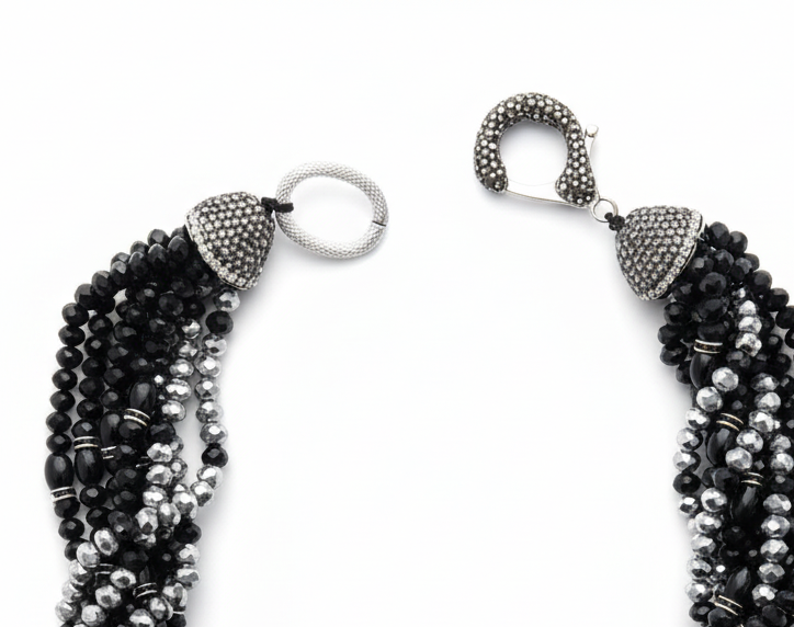 Elara Midnight Swan Necklace featuring layered faceted black and silver glass beads with rhinestone details and oversized pavé clasp.