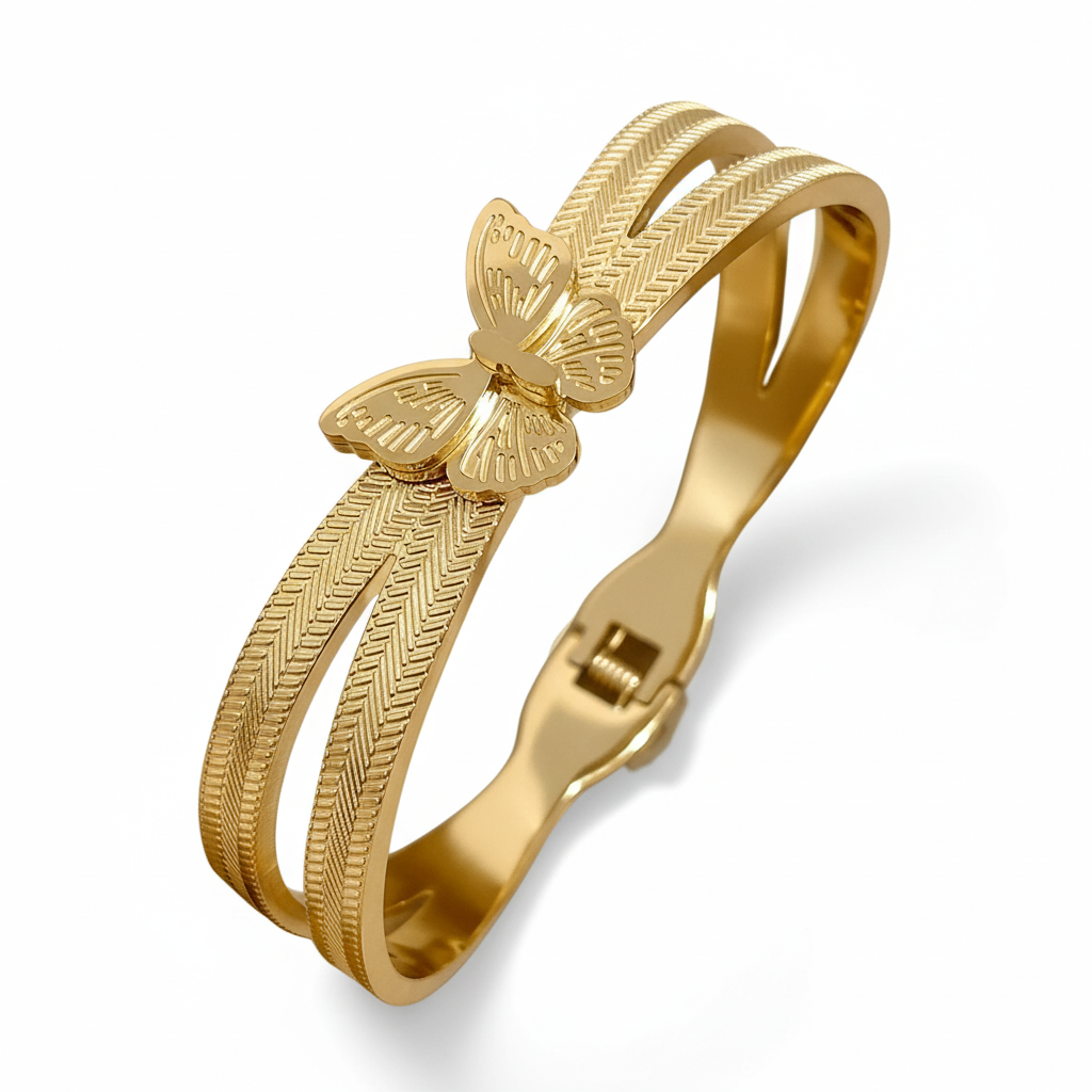 Gold bracelet with butterfly design on a white background. ZoharasVogue