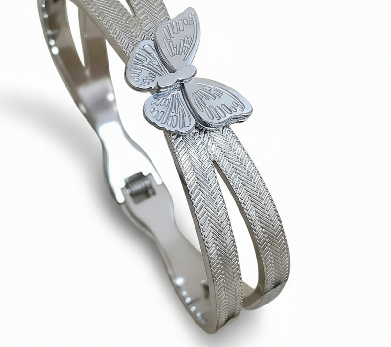 Silver bracelet with butterfly charm on a white background. ZoharasVogue