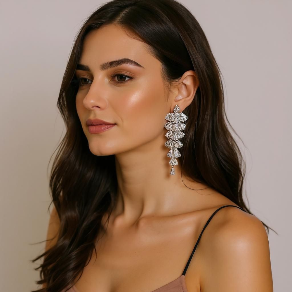 Tiered crystal drop earrings featuring sparkling clear stones in a cascading design, set in silver-tone zinc alloy with a silver post; elegant and bold fashion accessory for women. ZoharasVogue