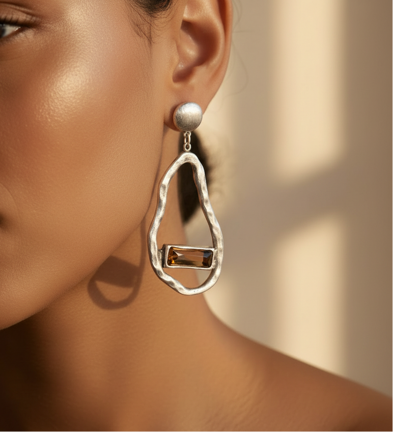 Model wearing Silver earrings with brown gemstones on a light gray background_ZoharasVogue