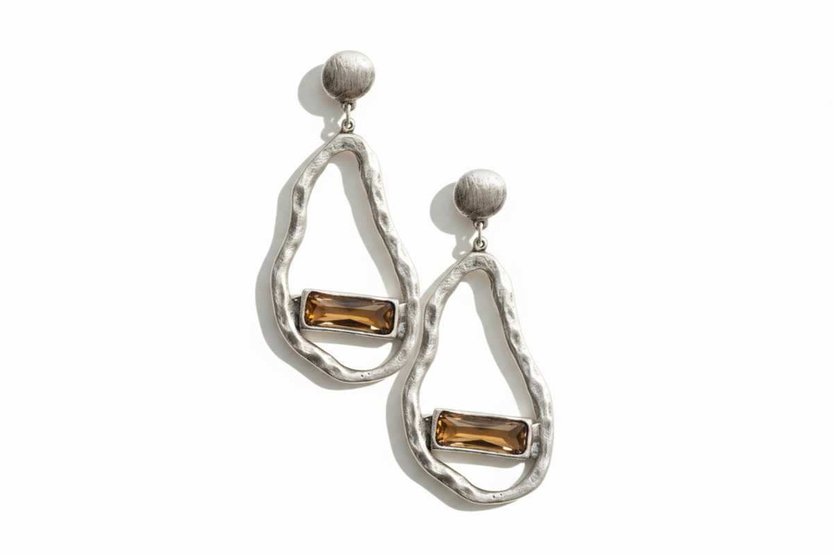 Pair of silver earrings with brown gemstones on a white background_ZoharasVogue