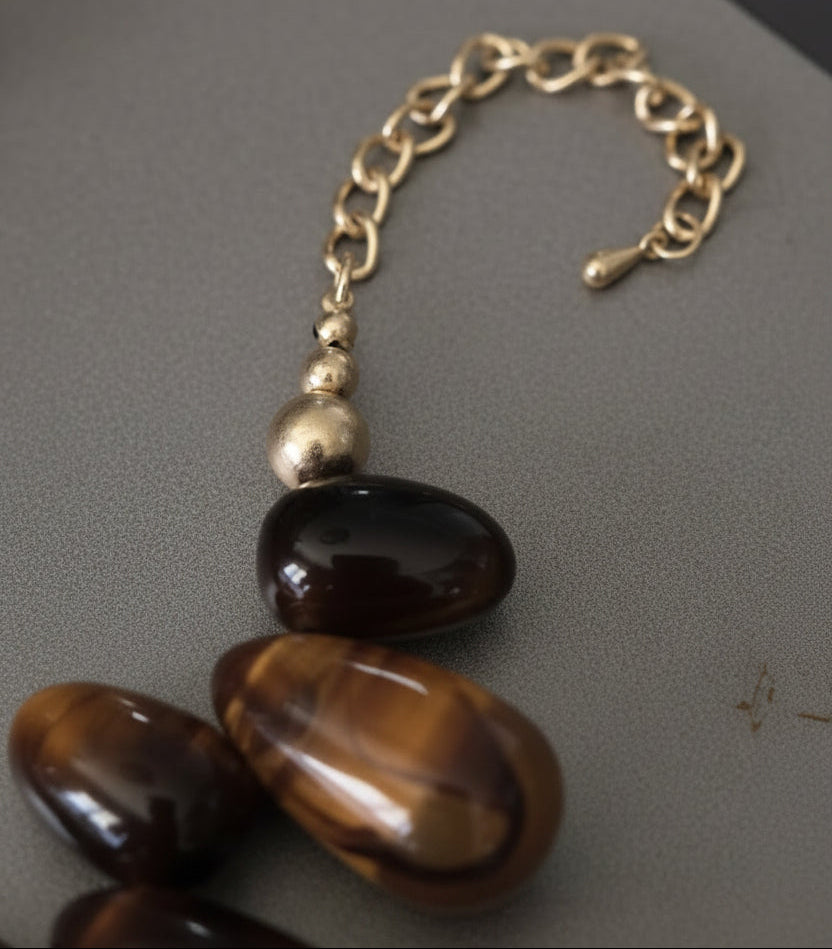 Necklace bold amber-toned statement necklace with layered beads and a textured oversized gold heart pendant