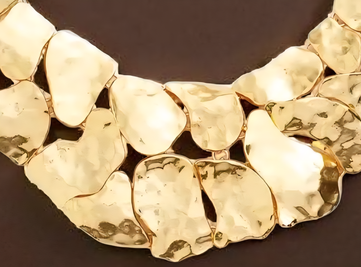 Crafted from 24-karat gold–plated pewter, this striking statement piece evokes the look of hammered metal polished to a luminous gleam. ZoharasVogue 