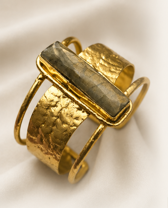 Labradorite Gold Cuff Bracelet with a central stone on a light background. 
