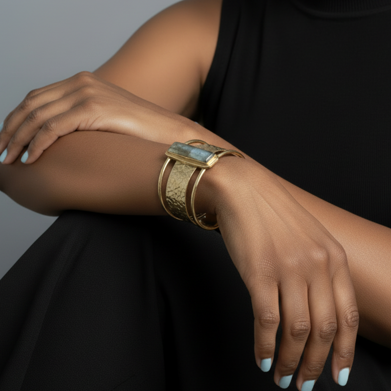 Model wearing a gold bracelet on a gray background_ZoharasVogue