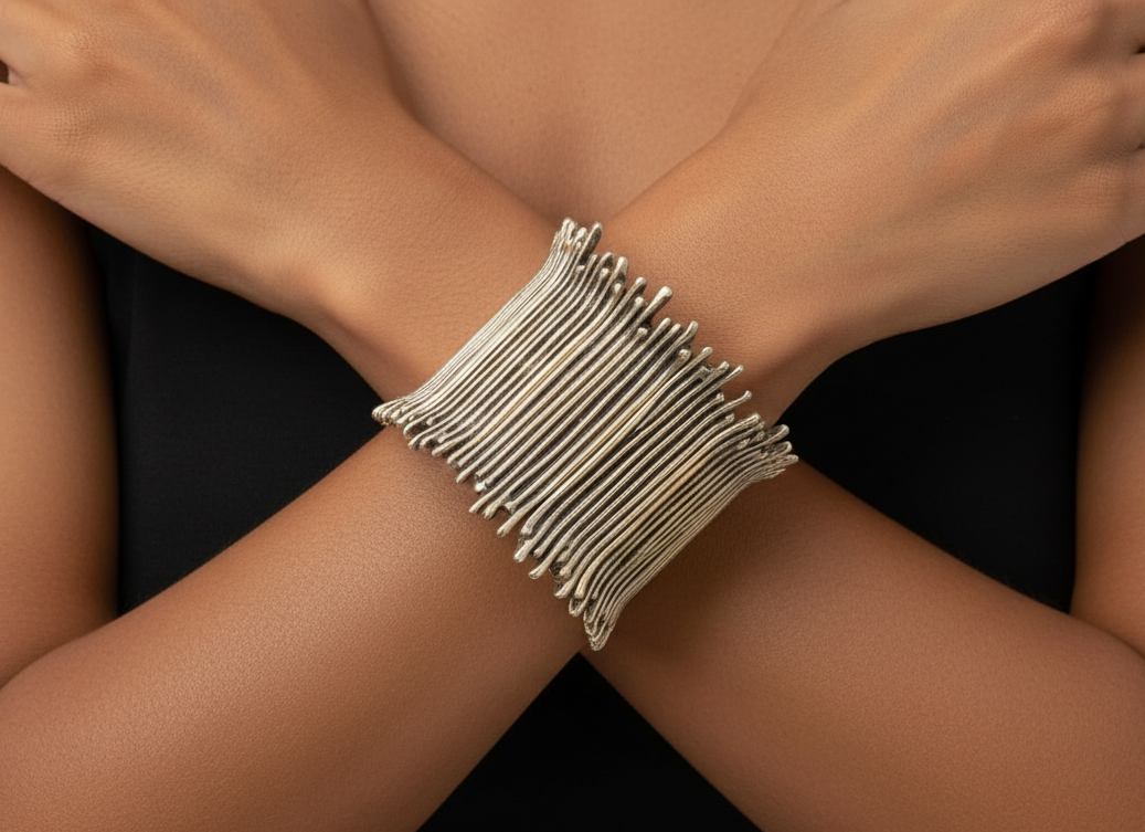 Silver bracelet on a wrist with a dark background_ZoharasVogue 