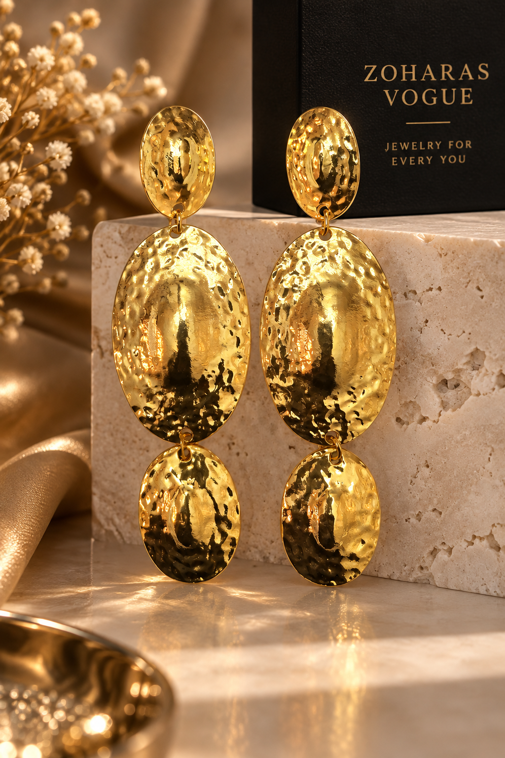 Moana Radiance oversized hammered gold statement earrings with three graduated oval drops and a reflective textured finish. ZOHARASVOGUE 