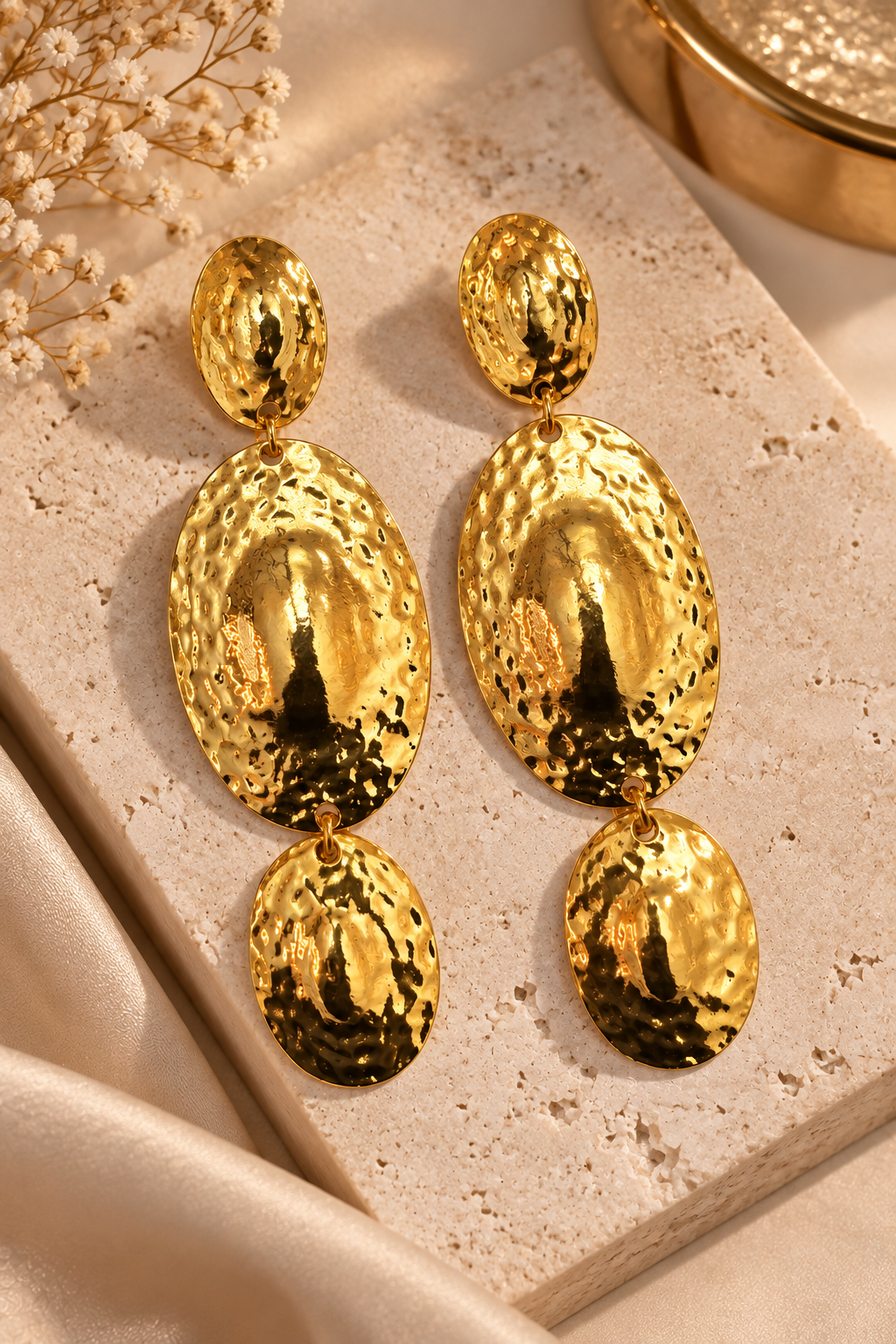 Moana Radiance oversized hammered gold statement earrings with three graduated oval drops and a reflective textured finish. ZoharasVogue 