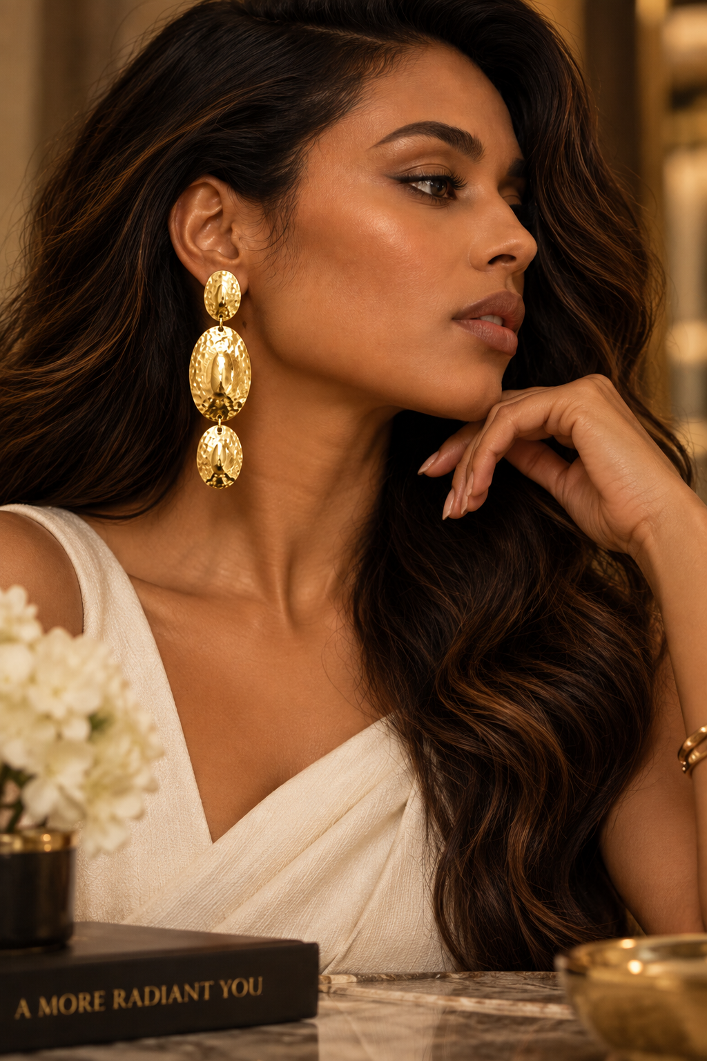 Moana Radiance oversized hammered gold statement earrings with three graduated oval drops and a reflective textured finish. ZoharasVogue 