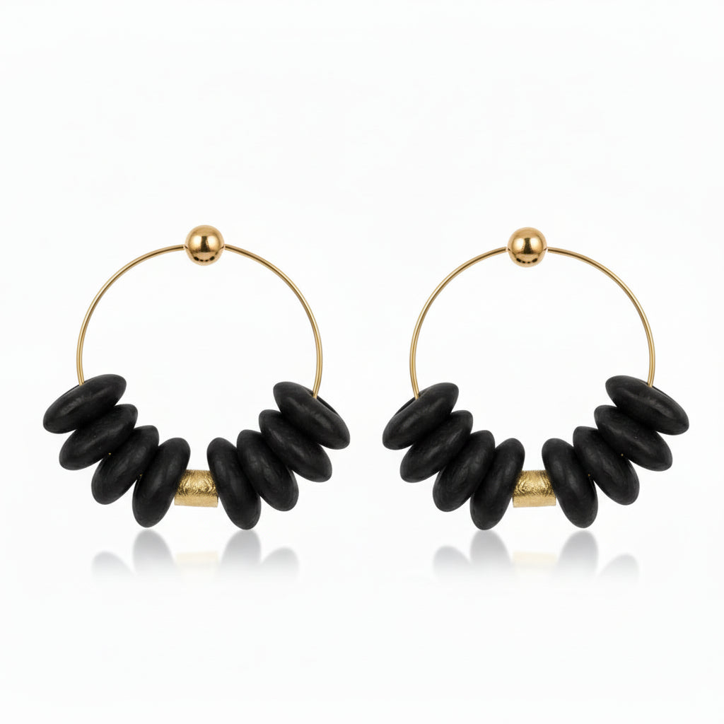 Pair of hoop earrings with black beads on a white background