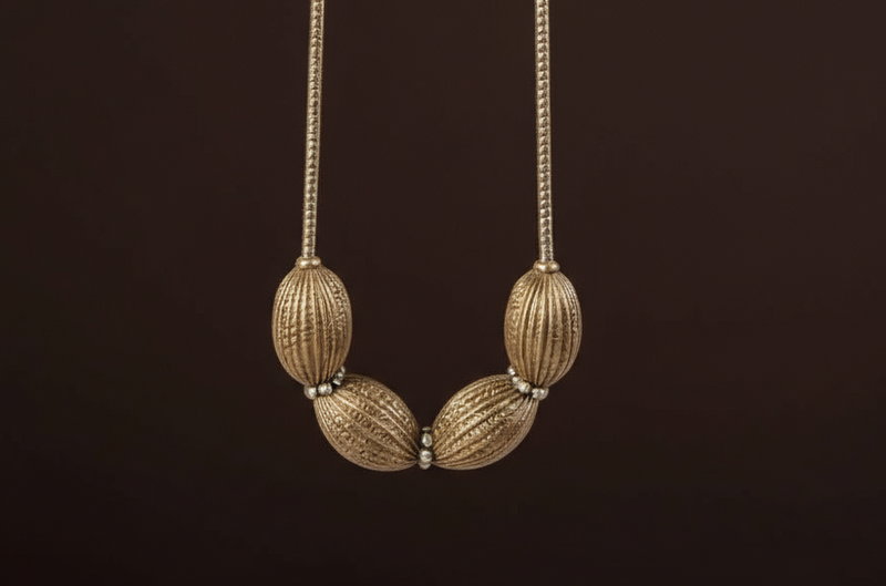 Close-up of the Obsidian Smoke Necklace featuring oversized ribbed oval beads in a gunmetal-tone finish with crystal spacer accents, arranged in a bold, sculptural design. ZoharasVogue 
