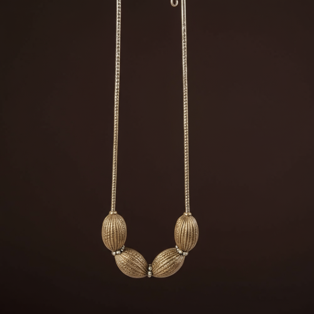 Close-up of the Obsidian Smoke Necklace featuring oversized ribbed oval beads in a gunmetal-tone finish with crystal spacer accents, arranged in a bold, sculptural design. ZoharasVogue 
