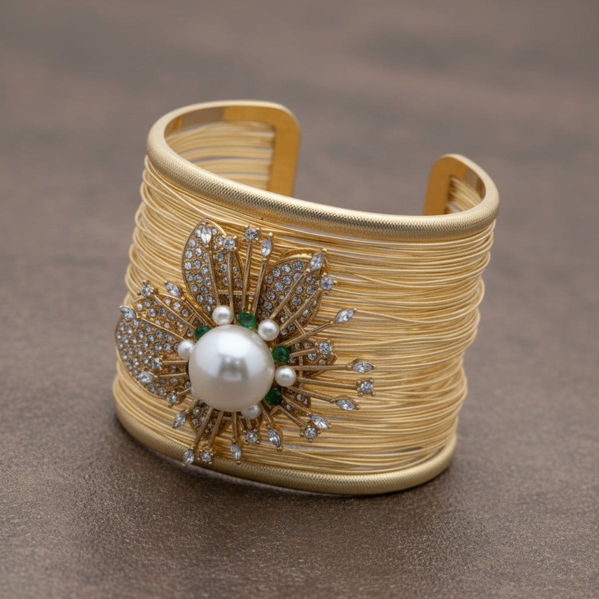 Gold bracelet with pearl and gemstone design on a white background. ZoharasVogue