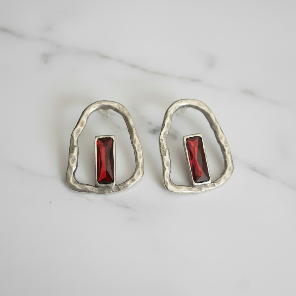 Silver plated boho-style earrings with a bold red stone centerpiece and organic sculpted design._ZoharasVogue