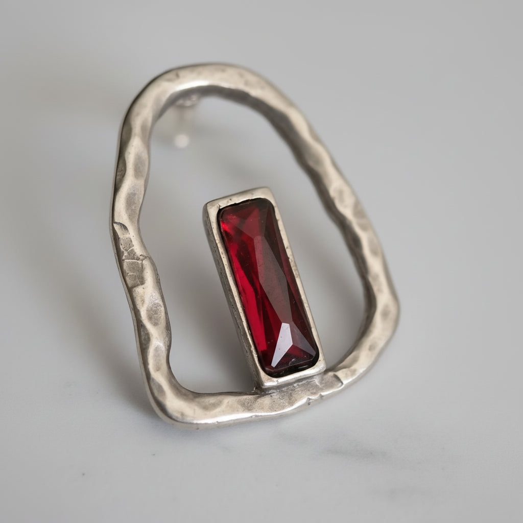 Silver plated boho-style earrings with a bold red stone centerpiece and organic sculpted design._ZoharasVogue