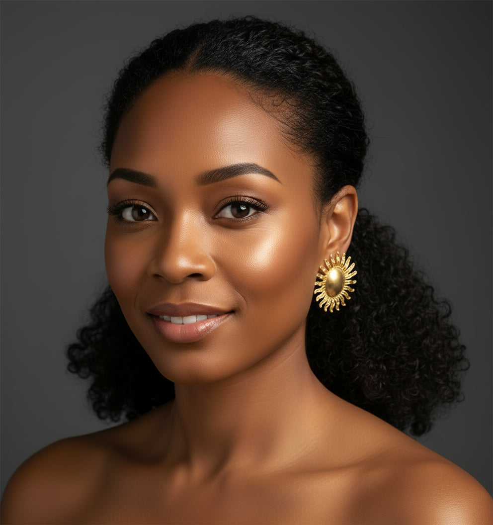 Pair of gold sun-shaped earrings on a white background_ZoarasVogue