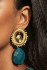 Solstice Eclipse Stone Earrings model wearing gold and turquoise earrings with a dark background_ZoharasVogue