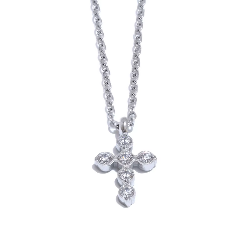 Silver cross necklace with small diamonds on a white background