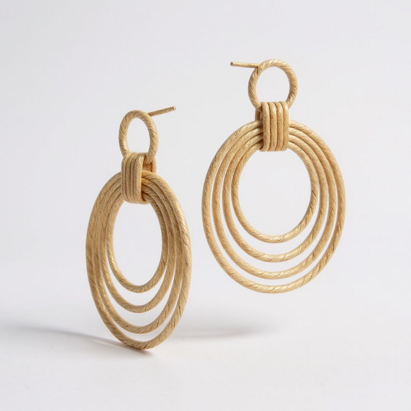 Lightweight 18K gold-plated hoop earrings with sculptural drop design and polished golden finish. ZoharasVogue