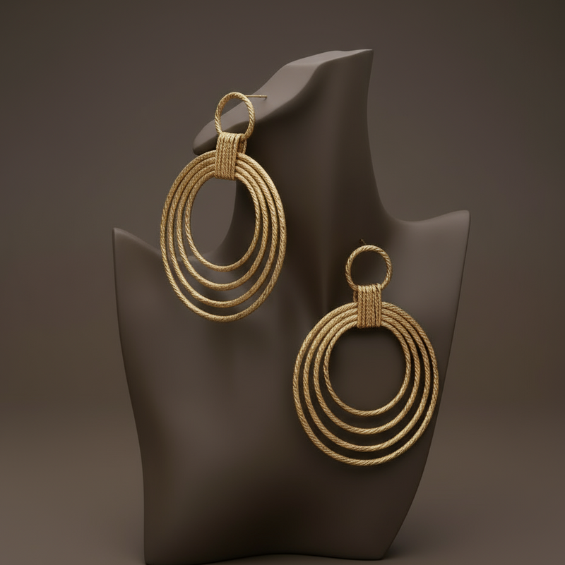 Lightweight 18K gold-plated hoop earrings with sculptural drop design and polished golden finish. ZoharasVogue