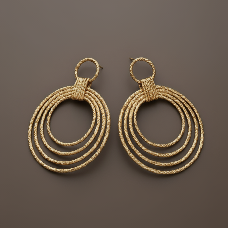 Lightweight 18K gold-plated hoop earrings with sculptural drop design and polished golden finish. ZoharasVogue