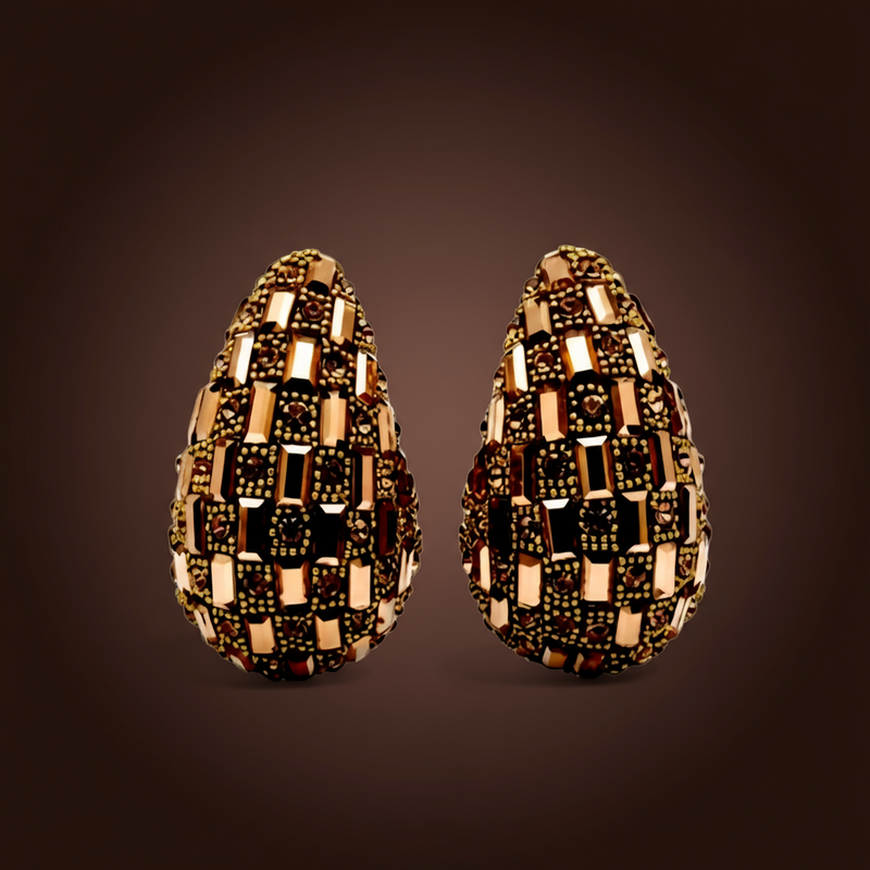 Pair of decorative earrings with a checkered pattern on a dark background