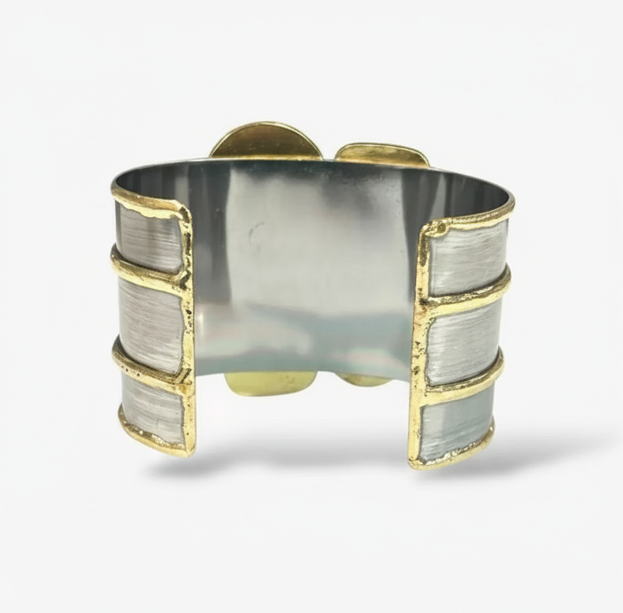 Handcrafted wide cuff bracelet with dark rectangular gemstones, pearl accents, and bold gold-tone detailing.