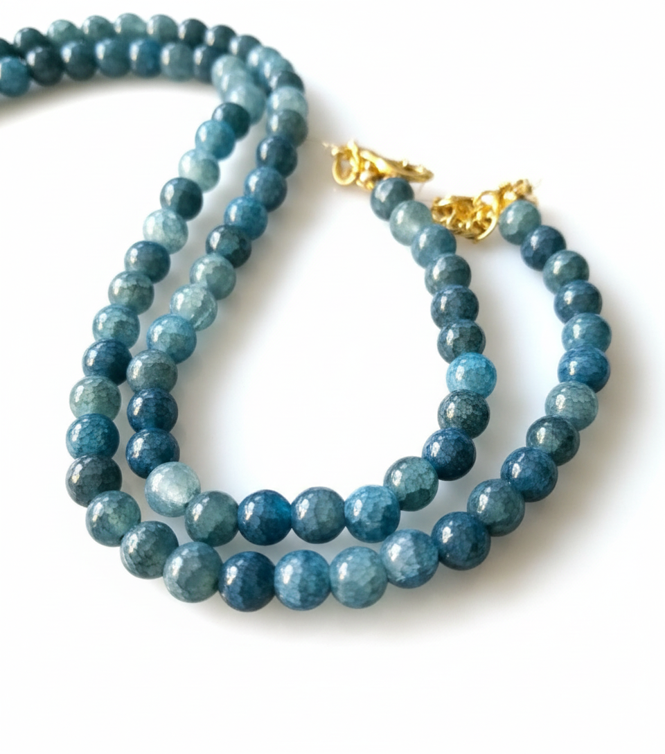 The Nyah Water Drop Necklace features a sculptural gold-tone beaded choker, lightweight CCB accents, and a geometric water-drop pendant. A vintage-inspired yet modern statement piece designed for bold, artistic styling. ZoharasVogue 