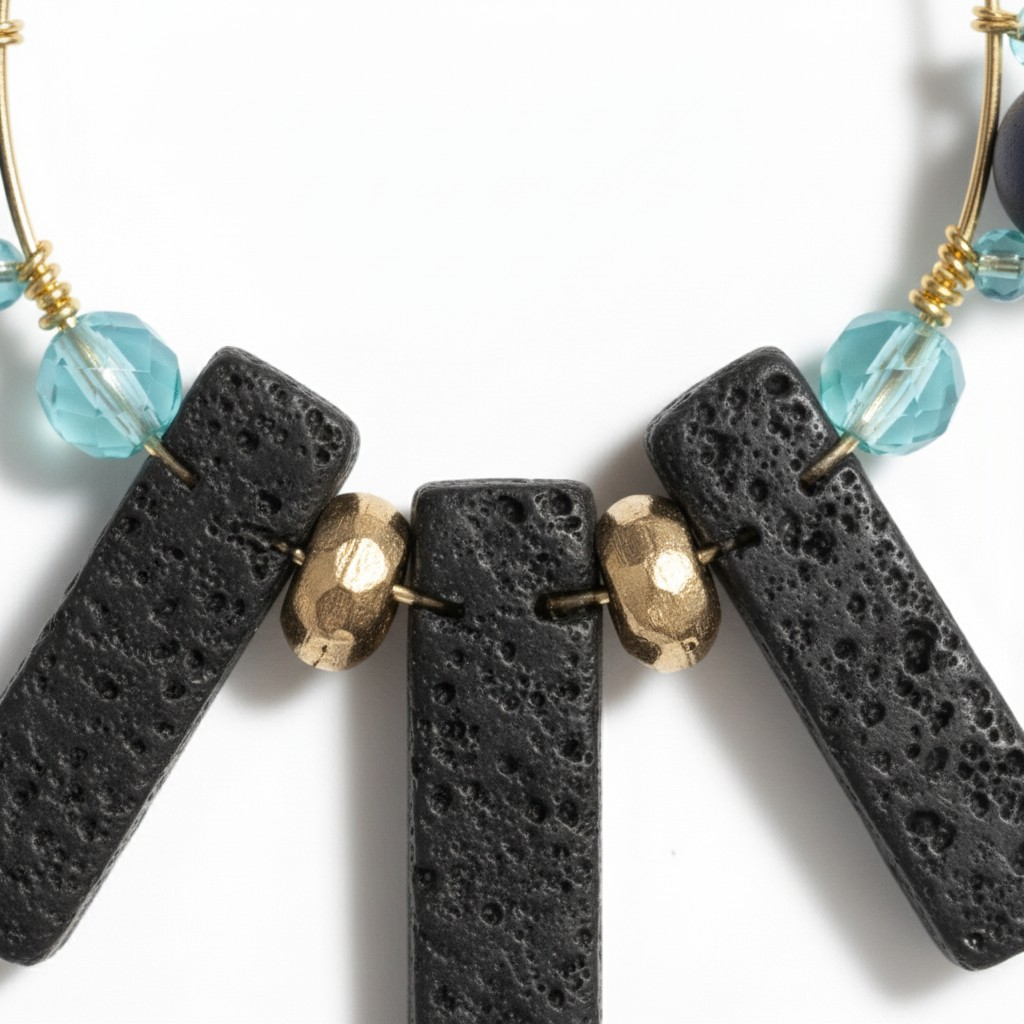 Handcrafted gold-tone statement earrings featuring a fan-shaped top, open hoop design, black textured bar beads, navy and aqua accent beads, gold spacers, and a small leaf charm. ZoharasVogue 