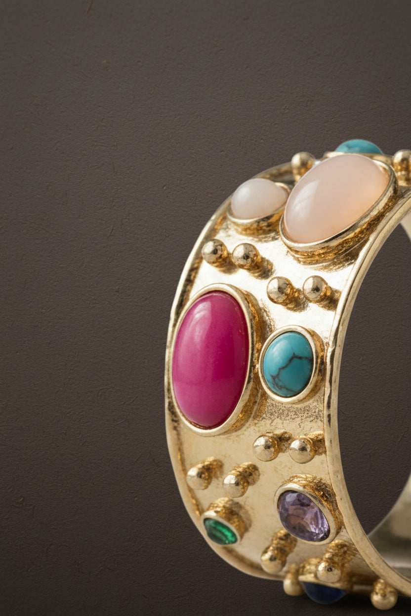 Gold ring with colorful gemstones on a white background_ ZoharasVogue 