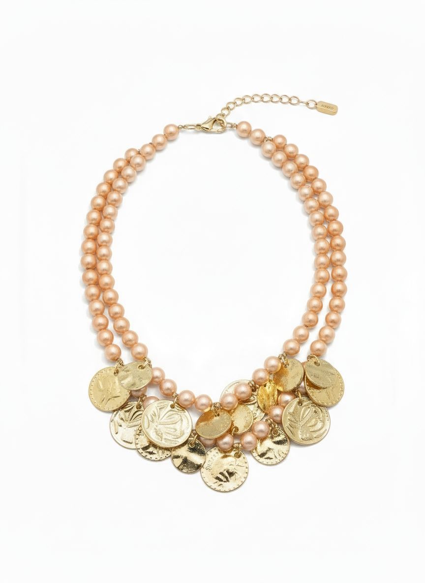Elegant statement necklace with double gold chains and warm amber glass stones styled on neutral background. ZoharasVogue