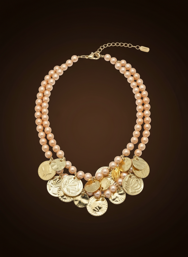 Elegant statement necklace with double gold chains and warm amber glass stones styled on neutral background. ZoharasVogue